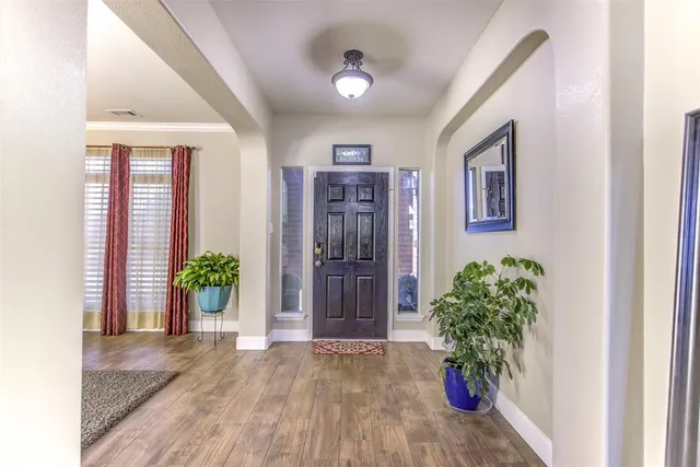 a view of an entryway with wooden floor