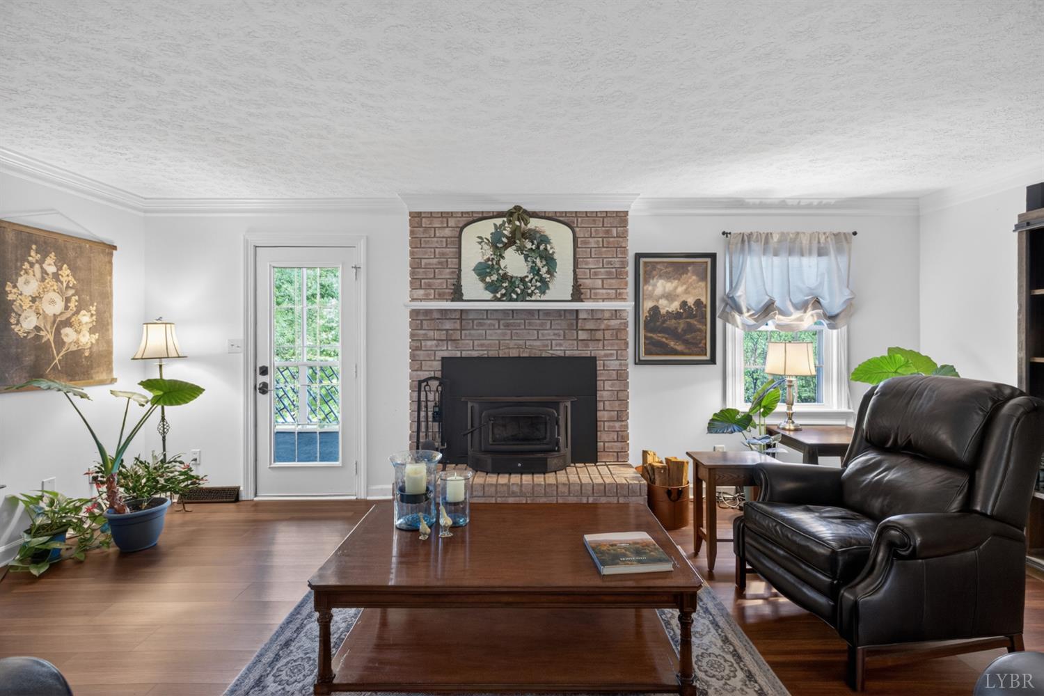 316 Quail Ridge Drive Forest, VA 24551 - Photo 7 of 35 a living room with furniture a potted plant and a fireplace