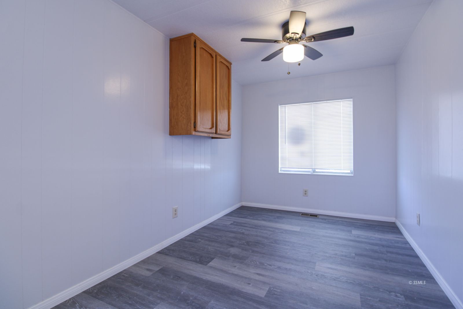 1441 West Iowa Avenue Ridgecrest, CA 93555 - Photo 23 of 27 wooden floor in an empty room with a window