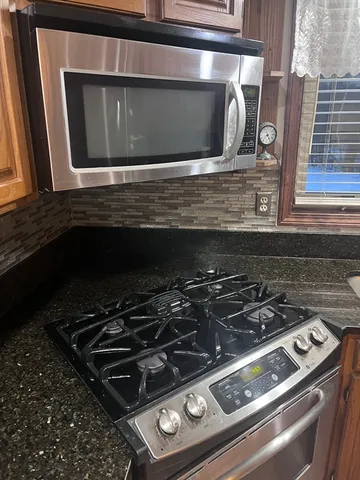 a stove top oven sitting inside of a kitchen