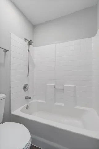 a bathroom with a bathtub and a toilet