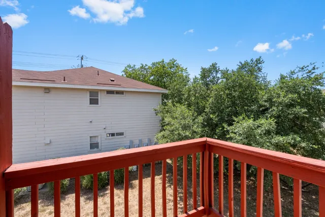 a view of a roof deck with wooden floor and fence