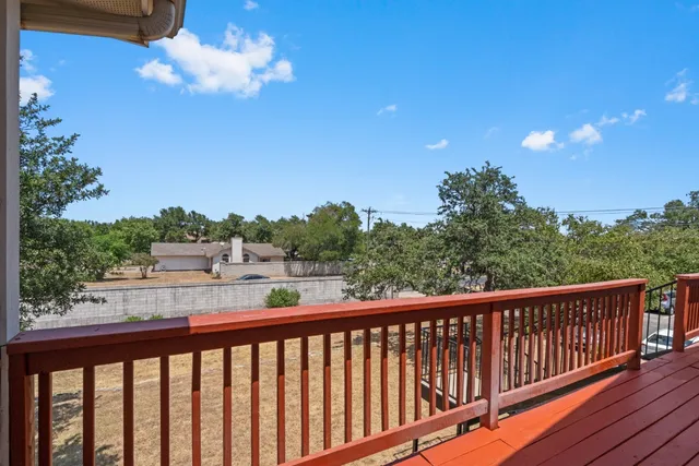a view of a balcony with wooden floor and outdoor space