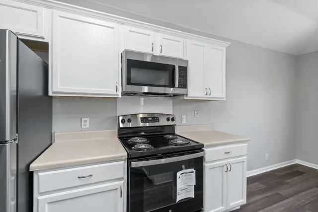 a kitchen with stainless steel appliances granite countertop a stove and a microwave