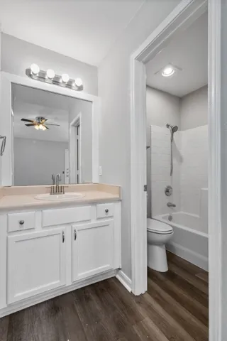 a bathroom with a toilet a sink a mirror and a bathtub