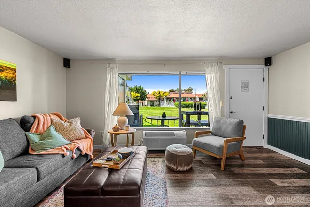 a living room with furniture and a floor to ceiling window