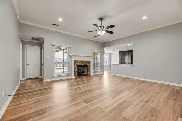 a view of an empty room with a fireplace and a window