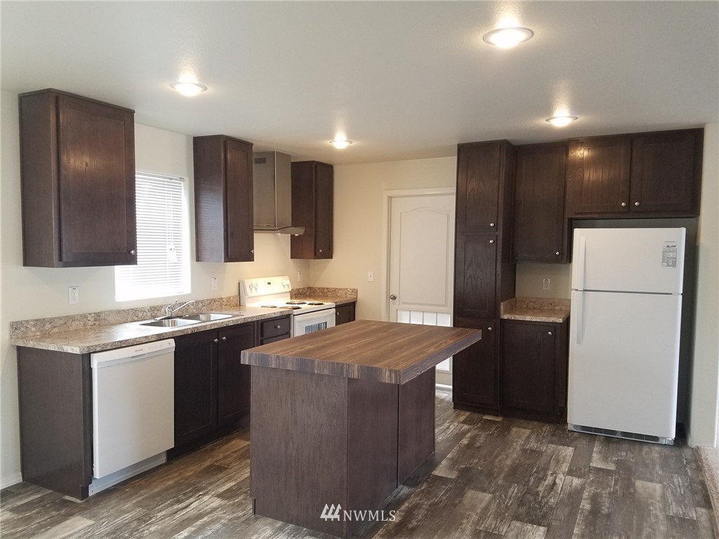 18940 Prairie Street Southwest Rochester, WA 98579 - Photo 3 of 22 a kitchen with stainless steel appliances granite countertop a refrigerator a sink a stove a microwave and island