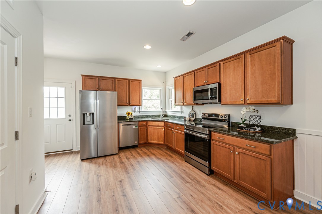 2018 Valentine Road Henrico, VA 23228 - Photo 43 of 65 a kitchen with stainless steel appliances granite countertop a refrigerator a stove top oven a sink dishwasher and wooden floor