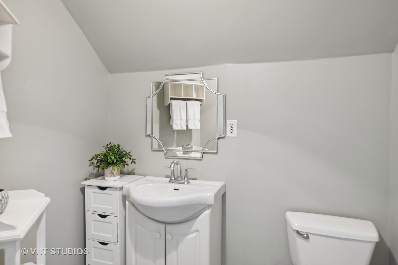 353 East Quincy Street Riverside, IL 60546 - Photo 12 of 21 a bathroom with a sink a toilet and mirror