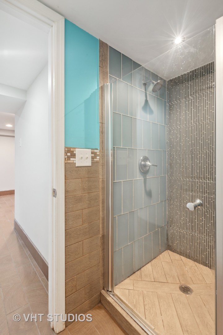 353 East Quincy Street Riverside, IL 60546 - Photo 15 of 21 a bathroom with a shower and a mirror