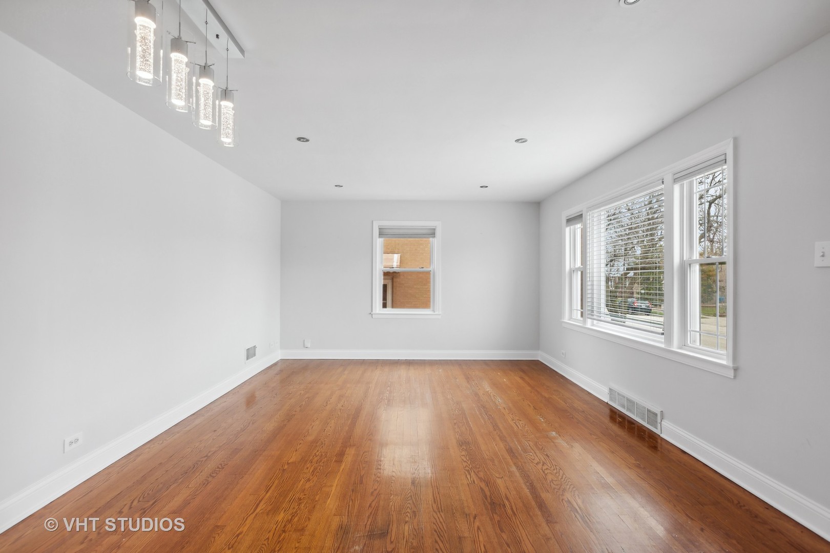353 East Quincy Street Riverside, IL 60546 - Photo 2 of 21 a view of an empty room with wooden floor and a window