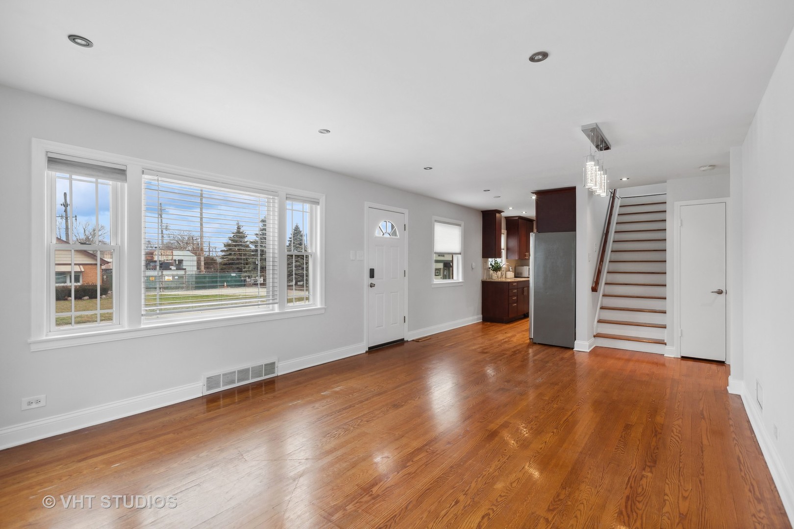353 East Quincy Street Riverside, IL 60546 - Photo 3 of 21 a view of an empty room with wooden floor and a window