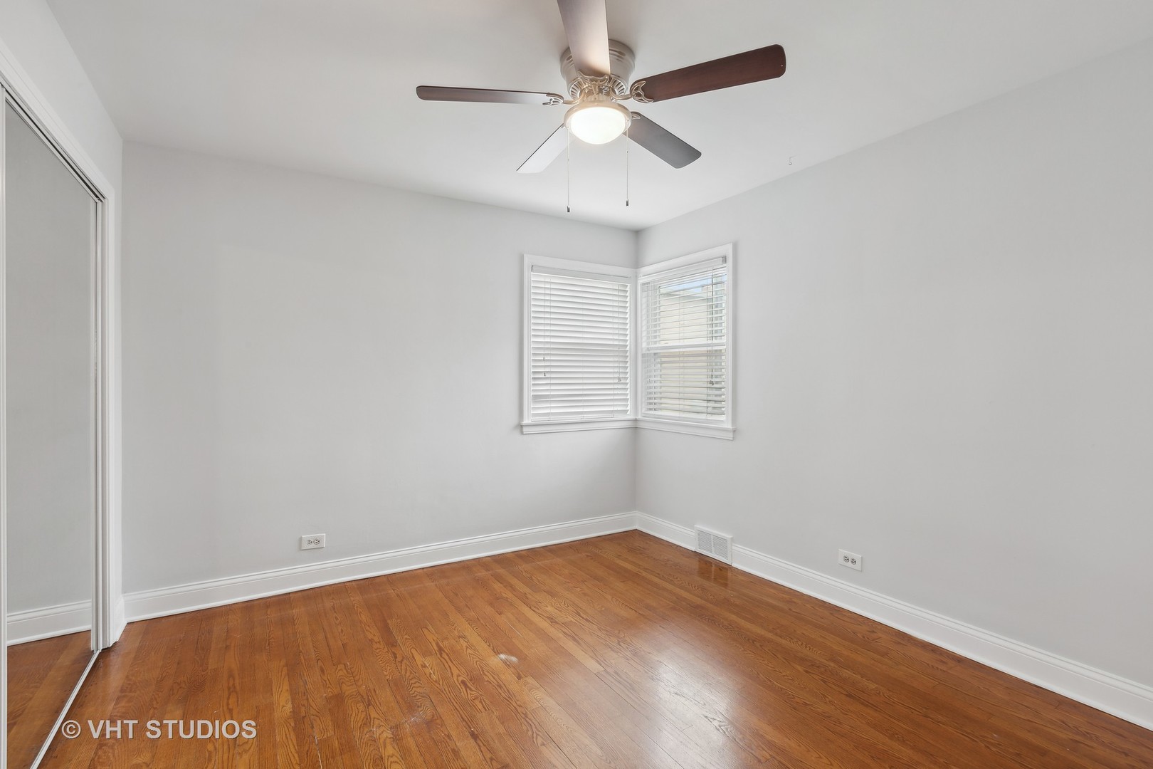 353 East Quincy Street Riverside, IL 60546 - Photo 6 of 21 an empty room with a window and a ceiling fan