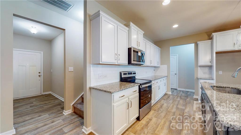 8550 River Ridge Drive Charlotte, NC 28213 - Photo 2 of 25 a kitchen with a stove a sink and a refrigerator