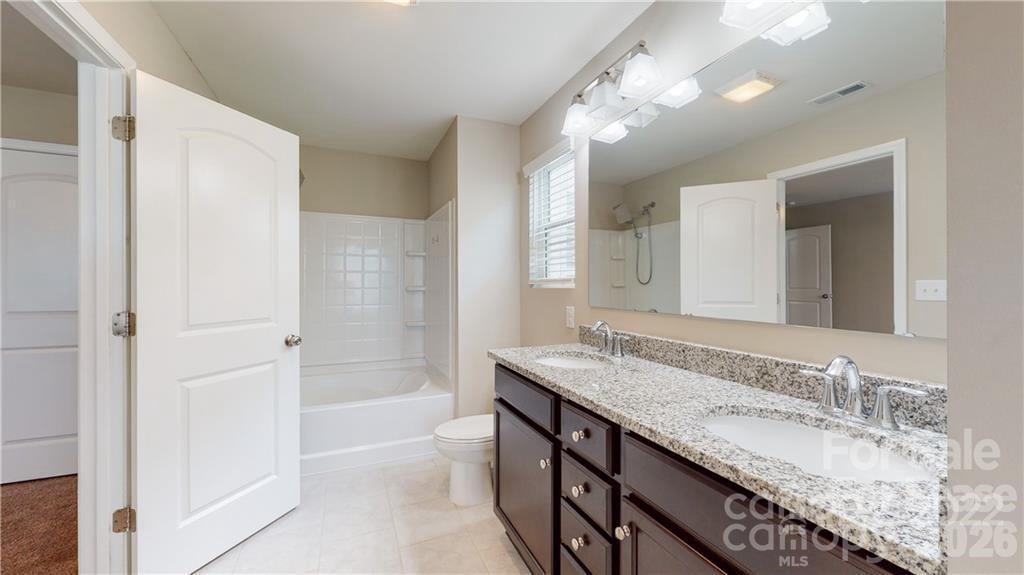 8550 River Ridge Drive Charlotte, NC 28213 - Photo 21 of 25 a bathroom with a granite countertop sink and a mirror