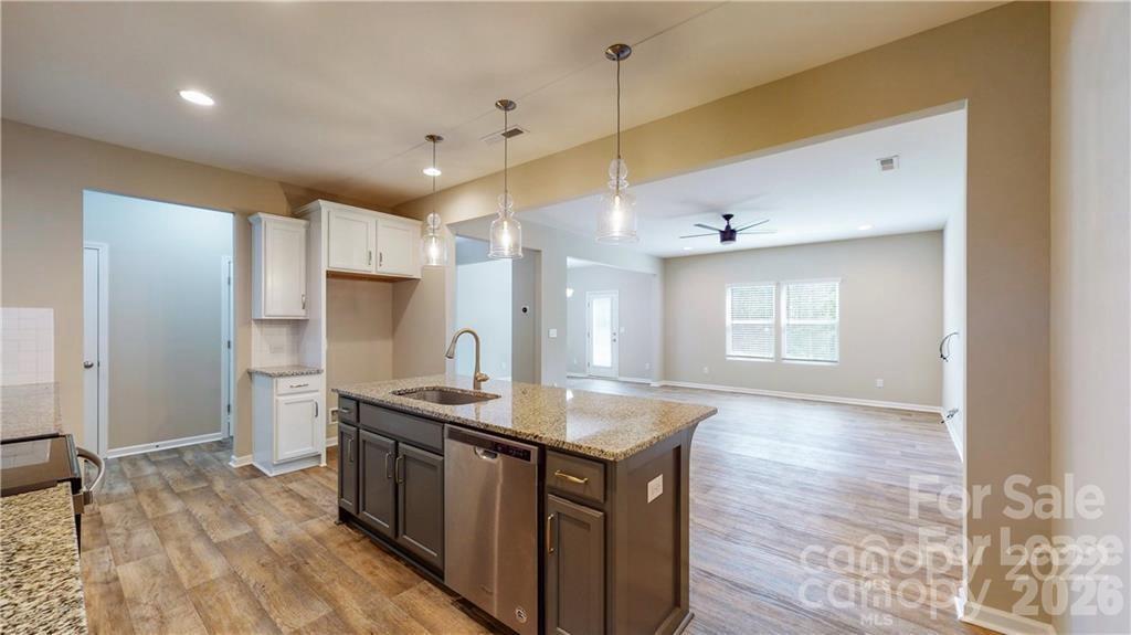 8550 River Ridge Drive Charlotte, NC 28213 - Photo 6 of 25 a kitchen with stainless steel appliances granite countertop a sink a stove and a wooden floors