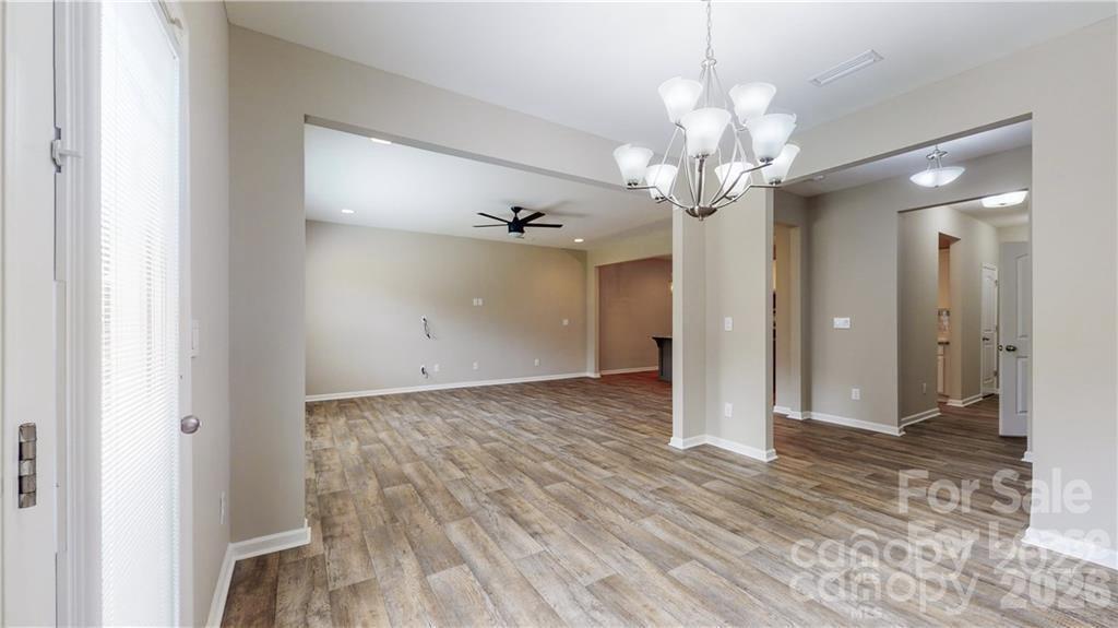 8550 River Ridge Drive Charlotte, NC 28213 - Photo 9 of 25 a view of a chandelier in big room with wooden floor