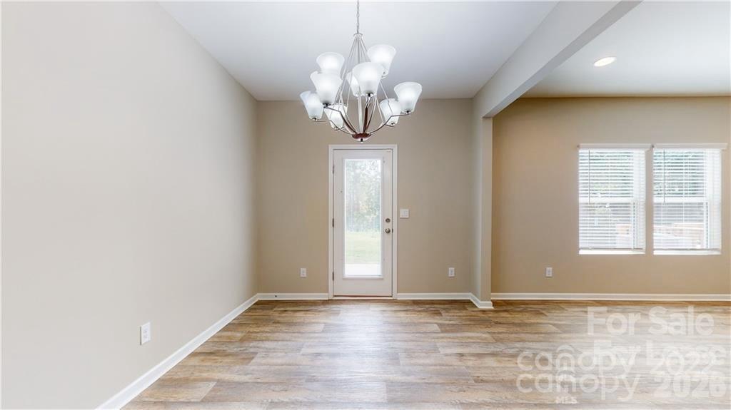 8550 River Ridge Drive Charlotte, NC 28213 - Photo 10 of 25 an empty room with wooden floor and windows