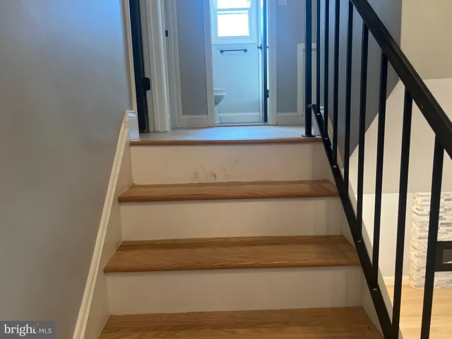 a view of staircase with white walls and a window