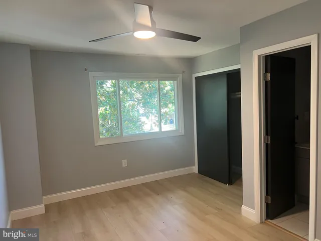 an empty room with windows and closet