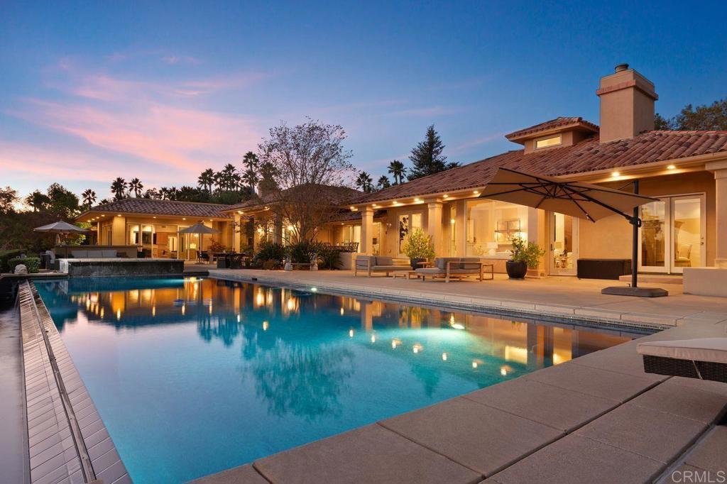 a view of a swimming pool with an outdoor seating