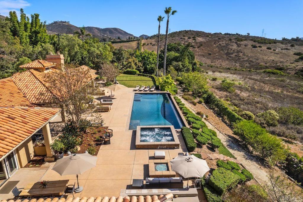 7196 Rancho La Cima Drive Rancho Santa Fe, CA 92067 - Photo 14 of 57 a view of a big yard with potted plants