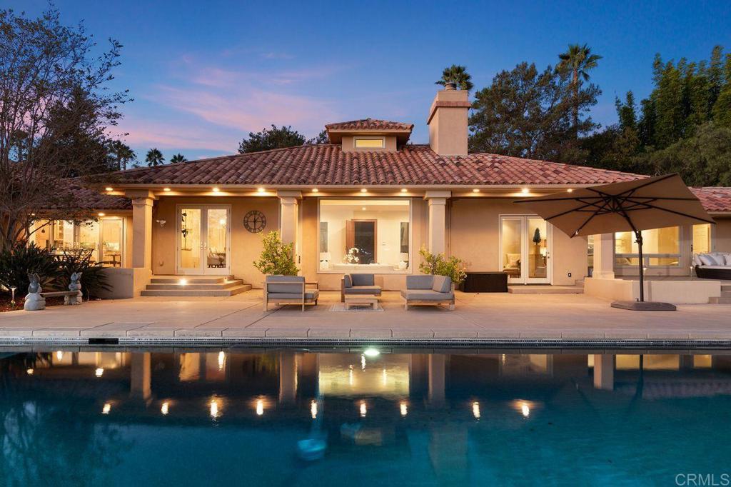 7196 Rancho La Cima Drive Rancho Santa Fe, CA 92067 - Photo 2 of 57 a view of a house with entertaining space