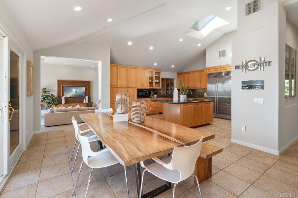 7196 Rancho La Cima Drive Rancho Santa Fe, CA 92067 - Photo 22 of 57 a dining room with a table and chairs