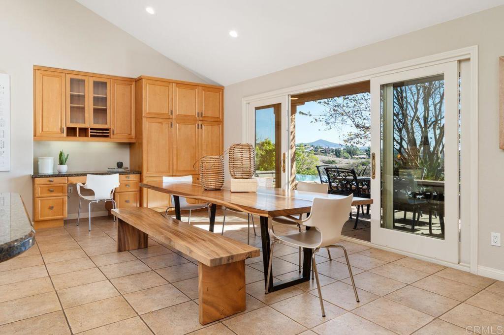 7196 Rancho La Cima Drive Rancho Santa Fe, CA 92067 - Photo 25 of 57 a dining room with furniture and large windows