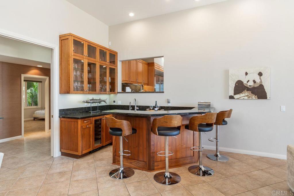 7196 Rancho La Cima Drive Rancho Santa Fe, CA 92067 - Photo 27 of 57 a kitchen with granite countertop breakfast area