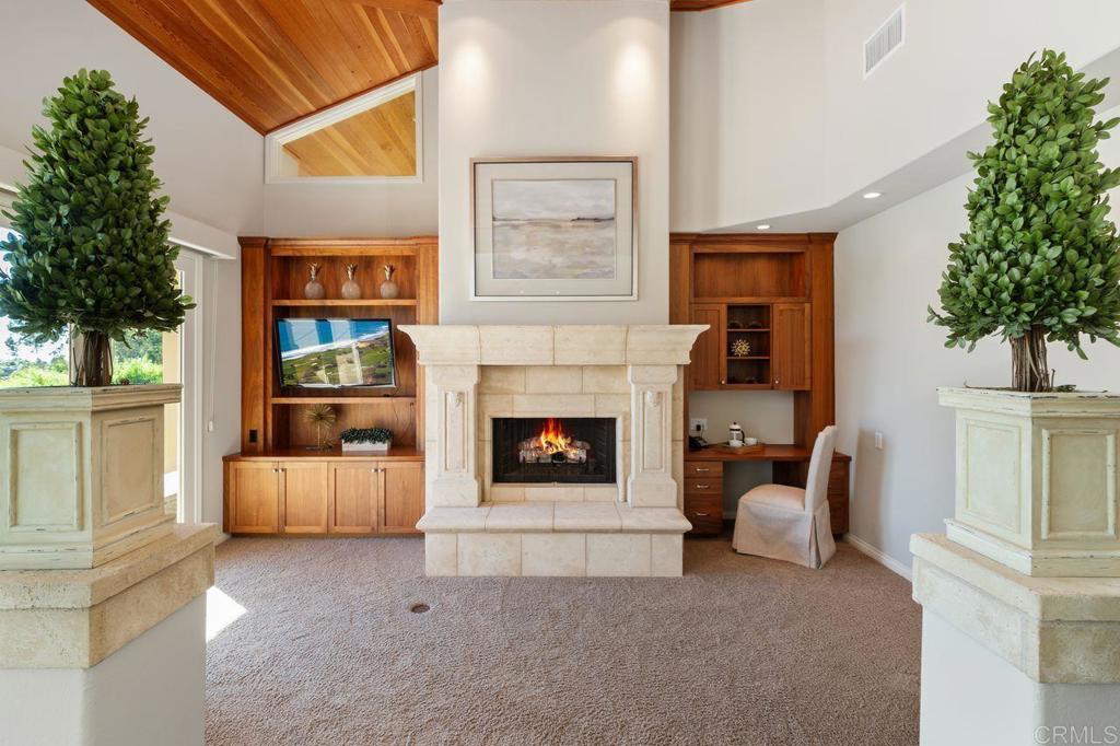 7196 Rancho La Cima Drive Rancho Santa Fe, CA 92067 - Photo 30 of 57 a living room with furniture and a fireplace
