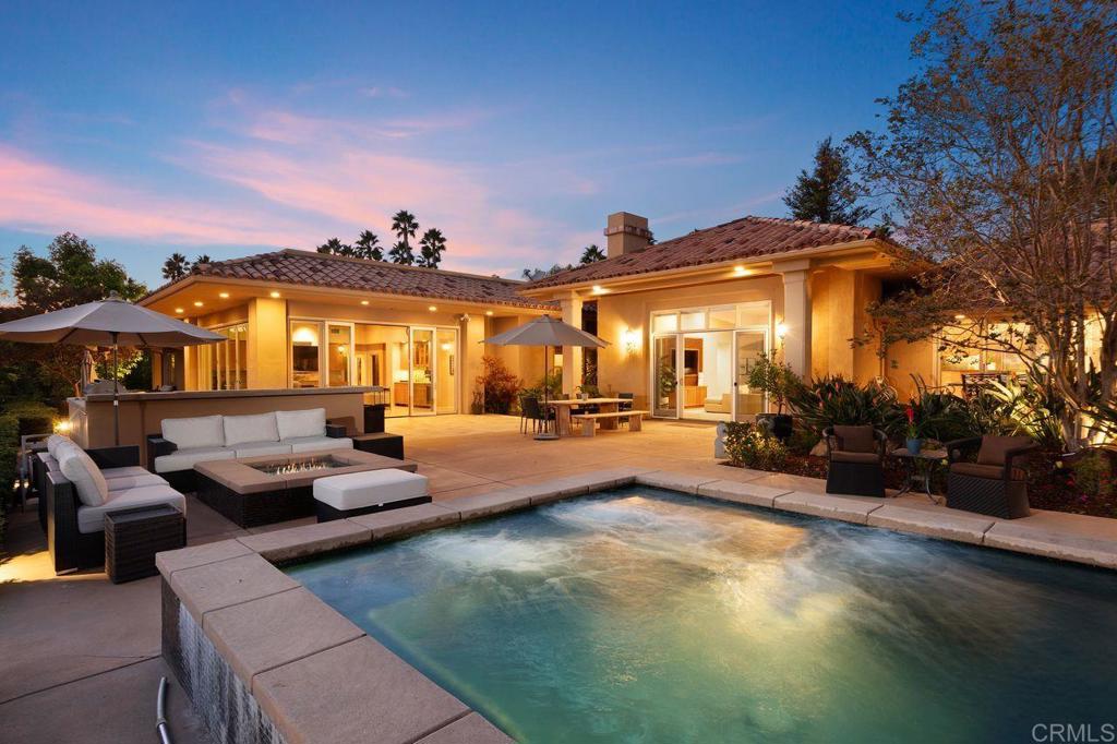 7196 Rancho La Cima Drive Rancho Santa Fe, CA 92067 - Photo 3 of 57 a view of a patio with swimming pool table and chairs