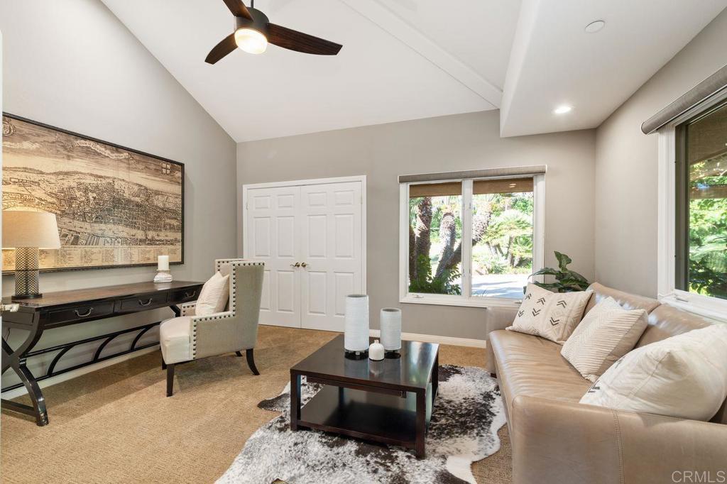 7196 Rancho La Cima Drive Rancho Santa Fe, CA 92067 - Photo 34 of 57 a living room with furniture and a large window