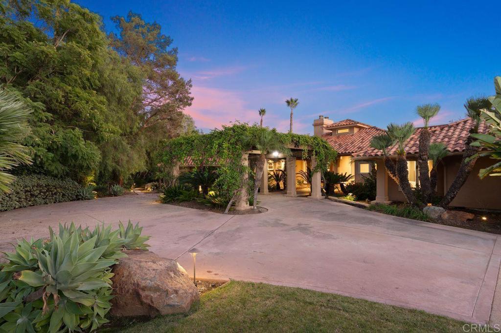 7196 Rancho La Cima Drive Rancho Santa Fe, CA 92067 - Photo 4 of 57 a view of a street with some trees