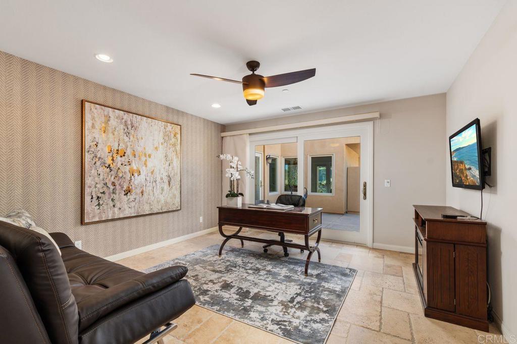 7196 Rancho La Cima Drive Rancho Santa Fe, CA 92067 - Photo 41 of 57 a living room with furniture and a flat screen tv
