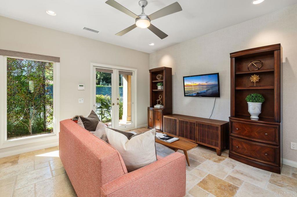 7196 Rancho La Cima Drive Rancho Santa Fe, CA 92067 - Photo 44 of 57 a living room with furniture and a flat screen tv