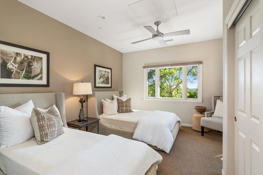 7196 Rancho La Cima Drive Rancho Santa Fe, CA 92067 - Photo 45 of 57 a bedroom with two beds and a large window