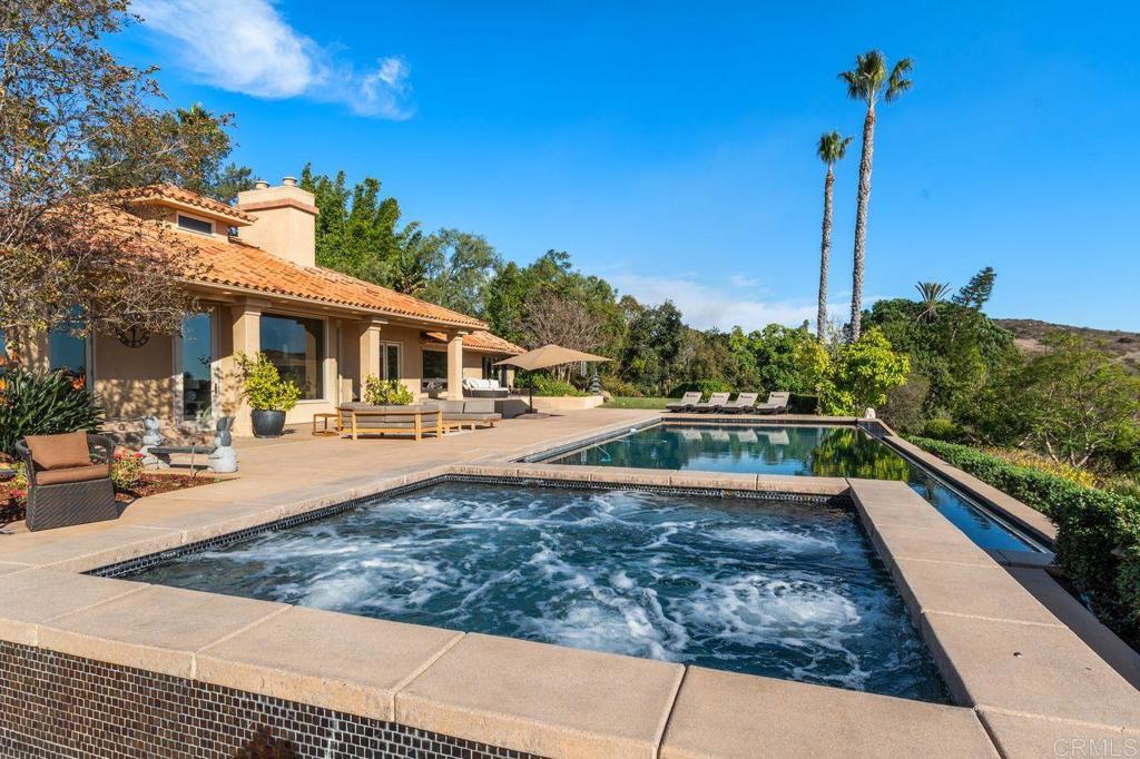 7196 Rancho La Cima Drive Rancho Santa Fe, CA 92067 - Photo 50 of 57 a view of a house with entertaining space