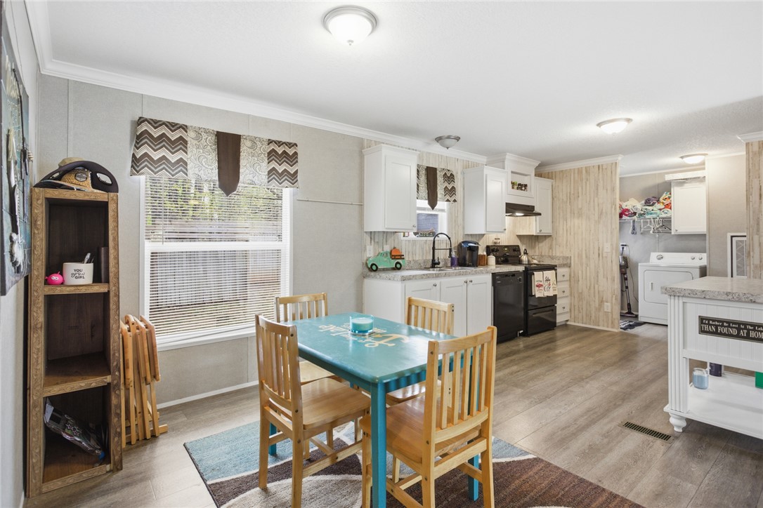 240 Southeast 147 Seneca, SC 29678 - Photo 11 of 26 This spacious kitchen and dining area features abundant natural light and a functional layout for daily living.