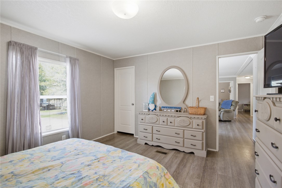 240 Southeast 147 Seneca, SC 29678 - Photo 14 of 26 This spacious bedroom offers serene views and a bright, inviting atmosphere with durable flooring.