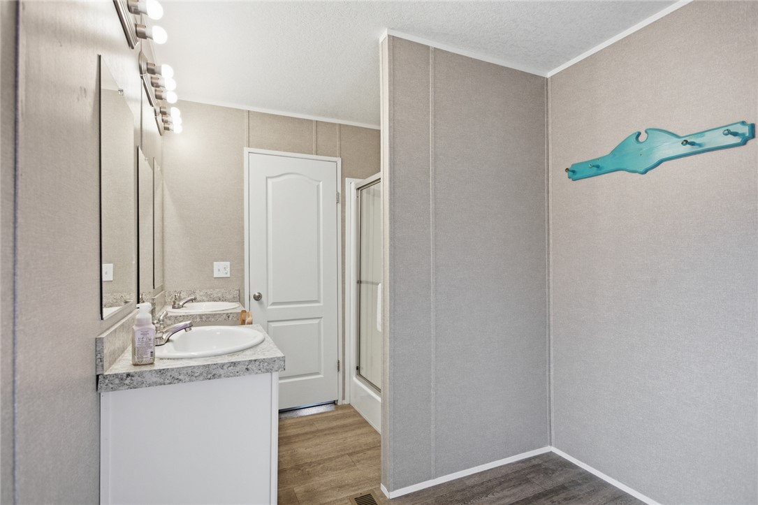 240 Southeast 147 Seneca, SC 29678 - Photo 16 of 26 This functional bathroom features dual vanities and a sleek walk-in shower for daily convenience.