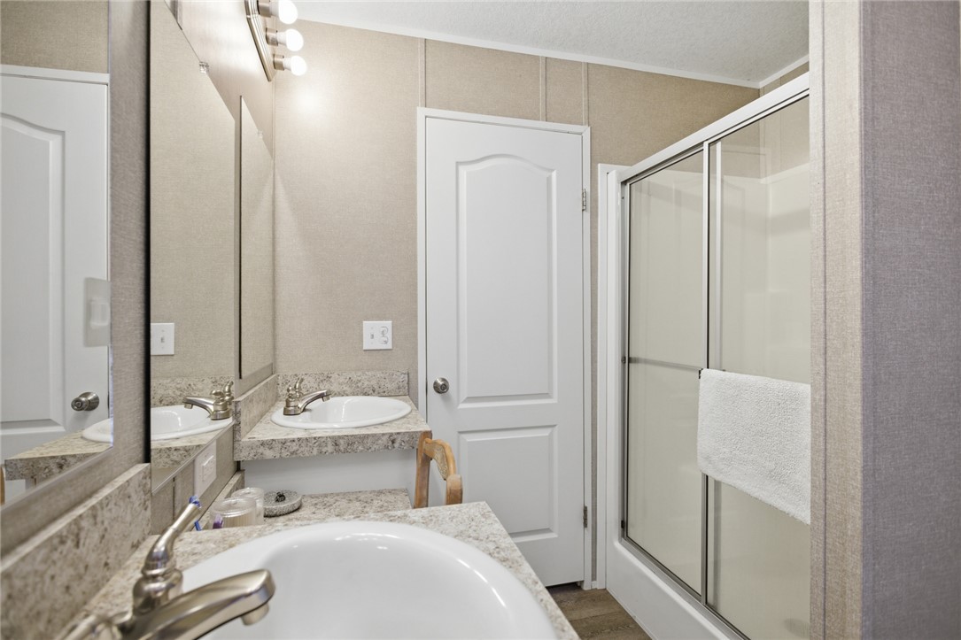 240 Southeast 147 Seneca, SC 29678 - Photo 17 of 26 This bathroom features a double vanity and a convenient walk-in shower.