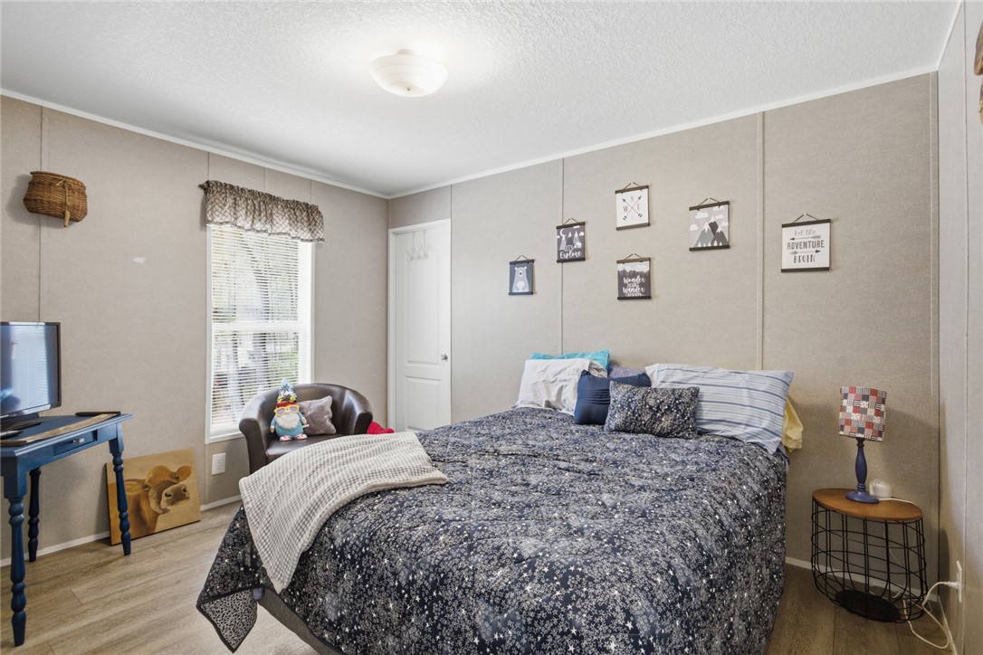 240 Southeast 147 Seneca, SC 29678 - Photo 18 of 26 This cozy bedroom features light wood flooring and a classic white door, offering a comfortable retreat.