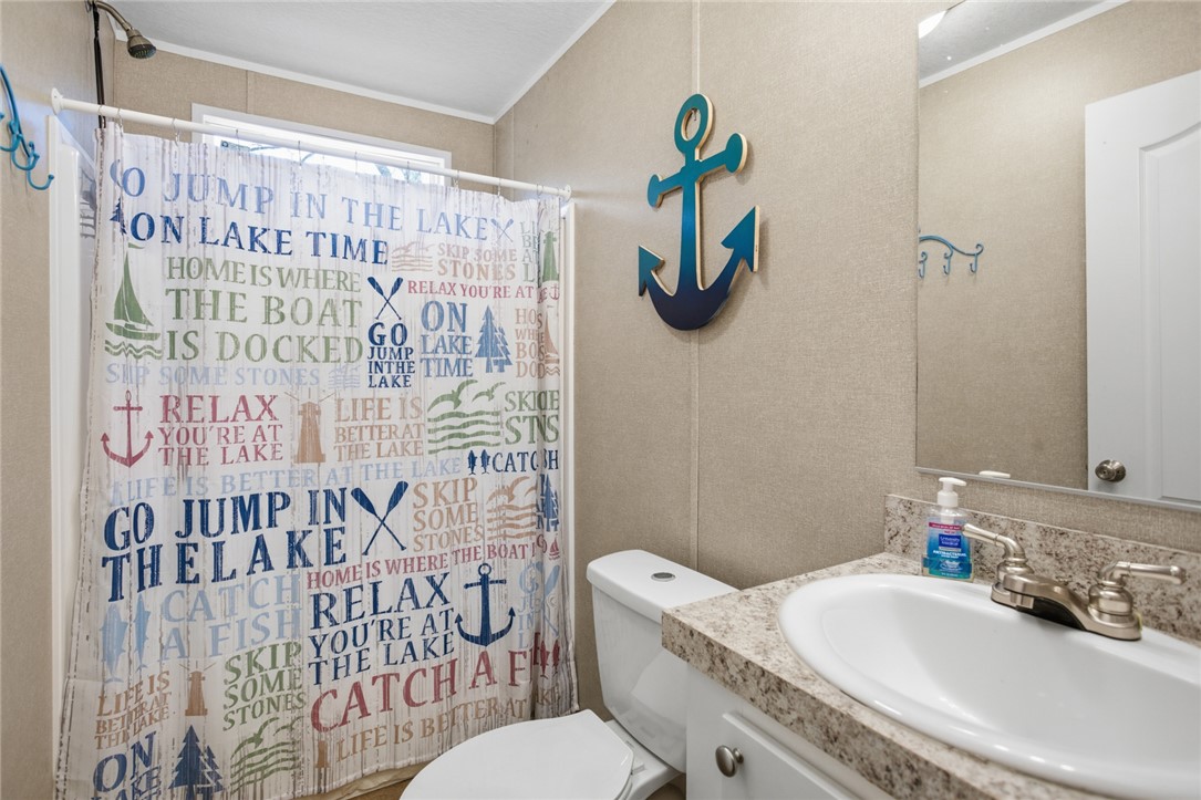 240 Southeast 147 Seneca, SC 29678 - Photo 19 of 26 This bright bathroom features a functional vanity and a refreshing shower.