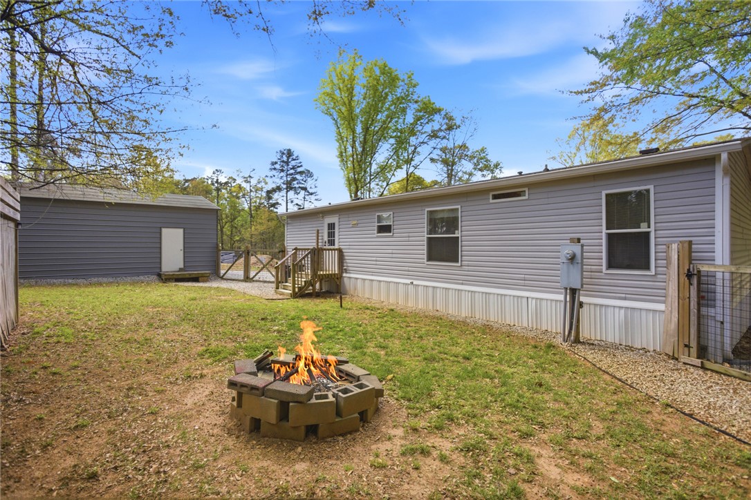 240 Southeast 147 Seneca, SC 29678 - Photo 5 of 26 Enjoy outdoor gatherings with a fire pit and a spacious yard.