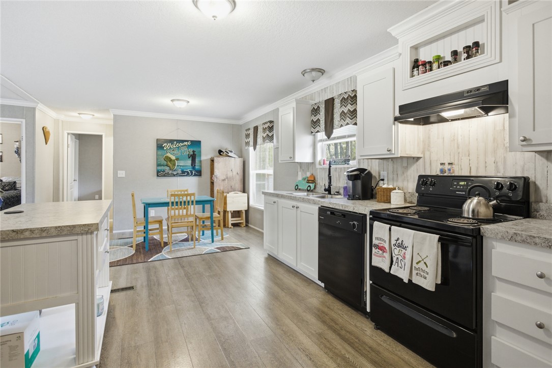 240 Southeast 147 Seneca, SC 29678 - Photo 9 of 26 This kitchen and dining area provides a functional and inviting space for everyday living.