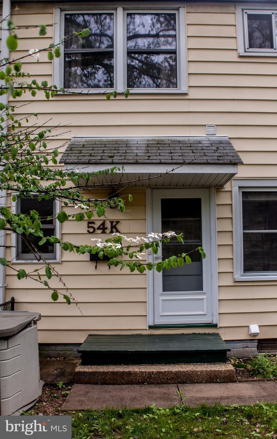 54 Ridge Road, Unit K Greenbelt, MD 20770 - Photo 1 of 29 a front view of a house with potted plants