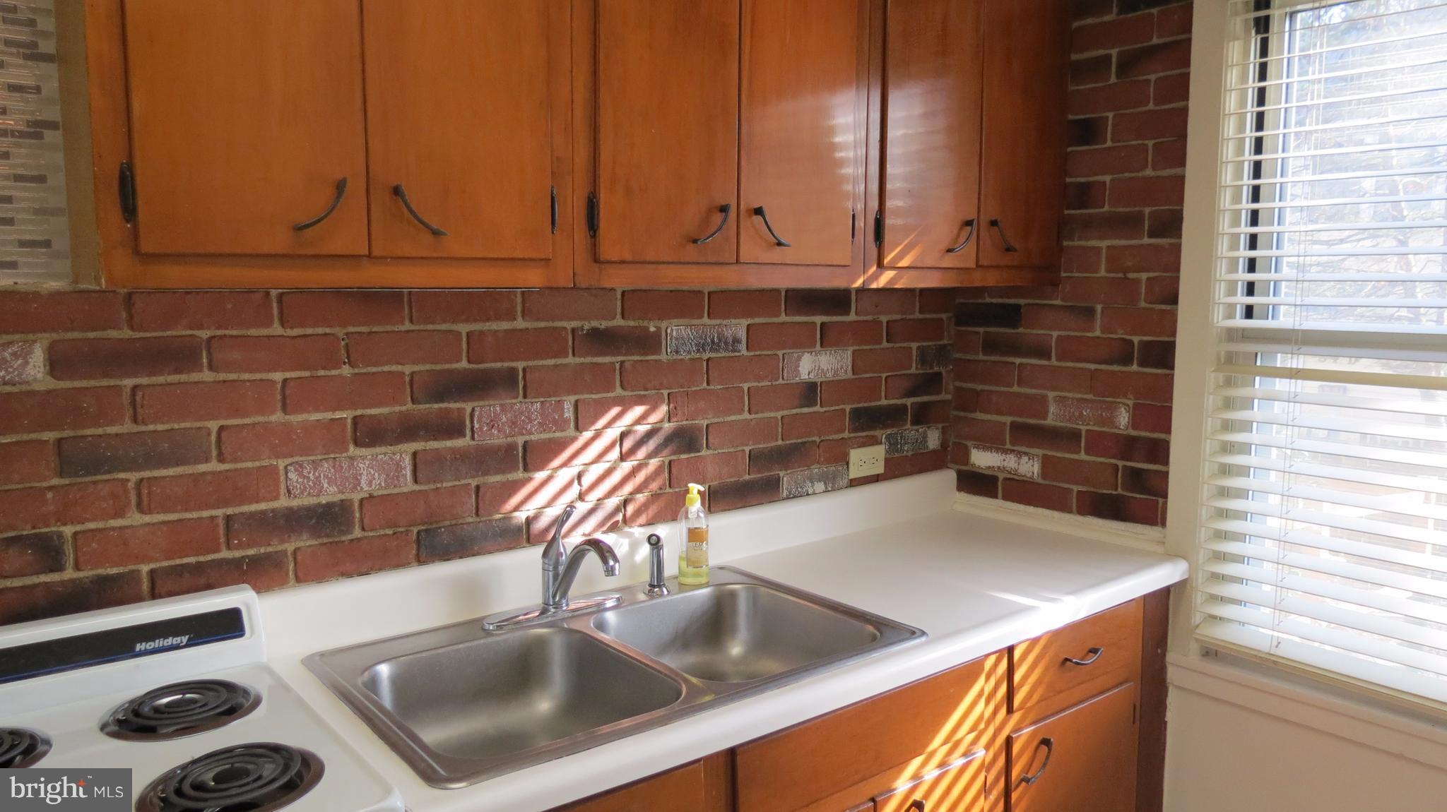 54 Ridge Road, Unit K Greenbelt, MD 20770 - Photo 2 of 29 a kitchen with a sink and cabinets