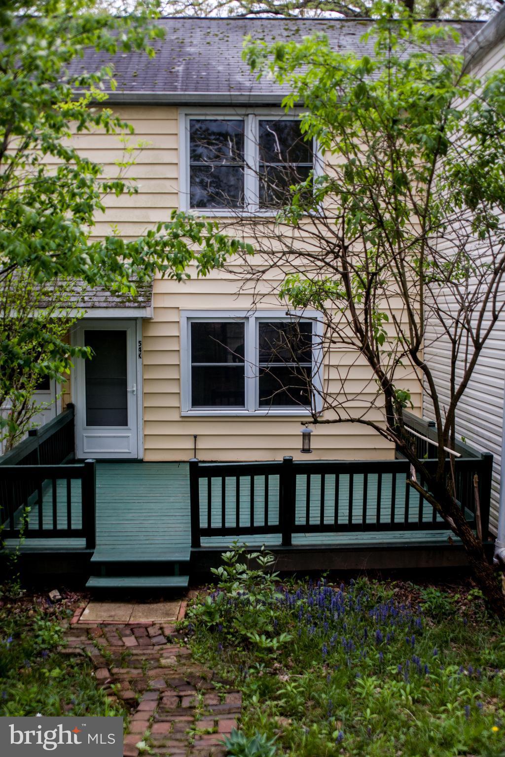 54 Ridge Road, Unit K Greenbelt, MD 20770 - Photo 19 of 29 a view of a house with brick walls and a small yard